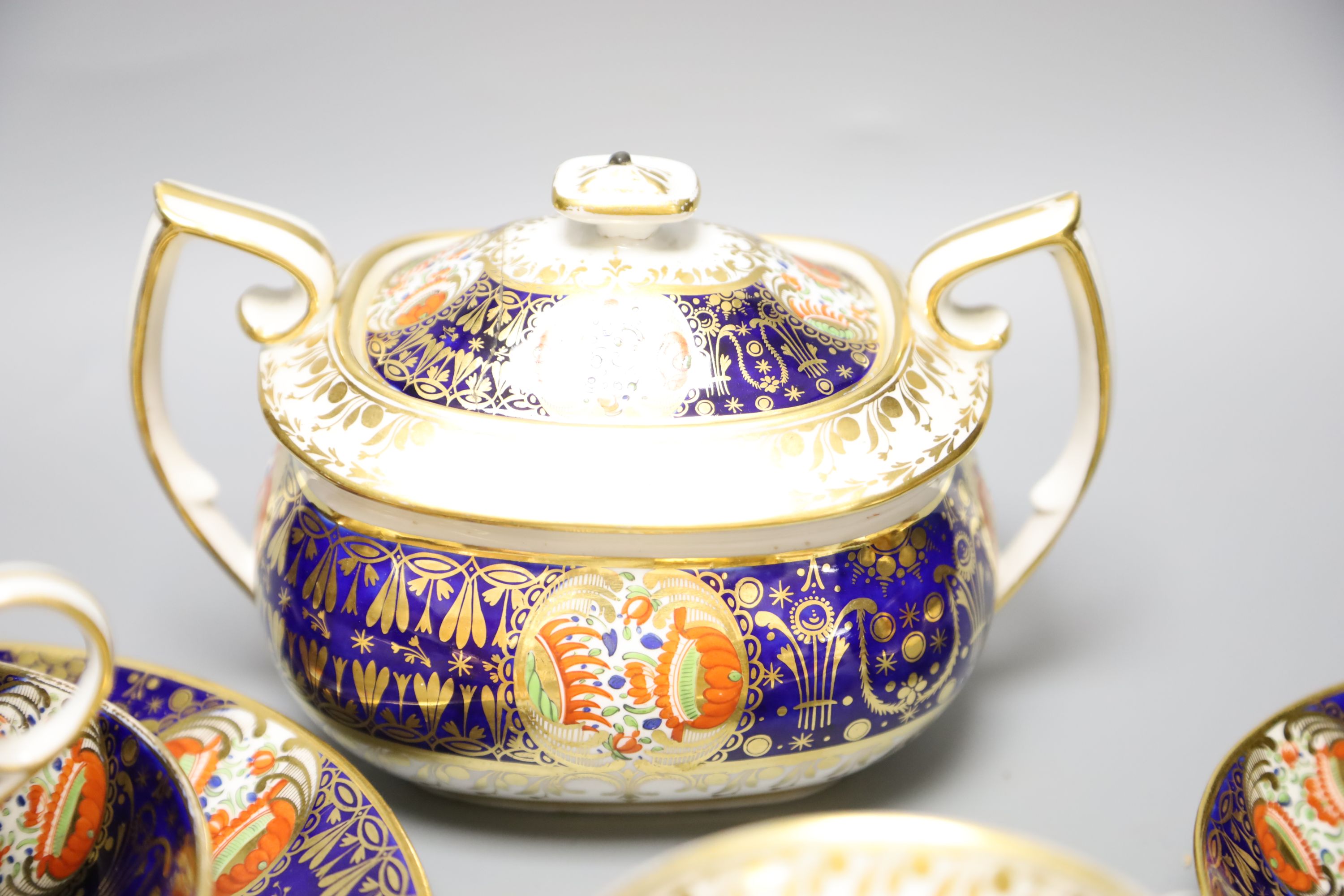 An early 19th century Chamberlains Worcester imari-style graduated set of three cups and saucers, a plate and a sucrier and